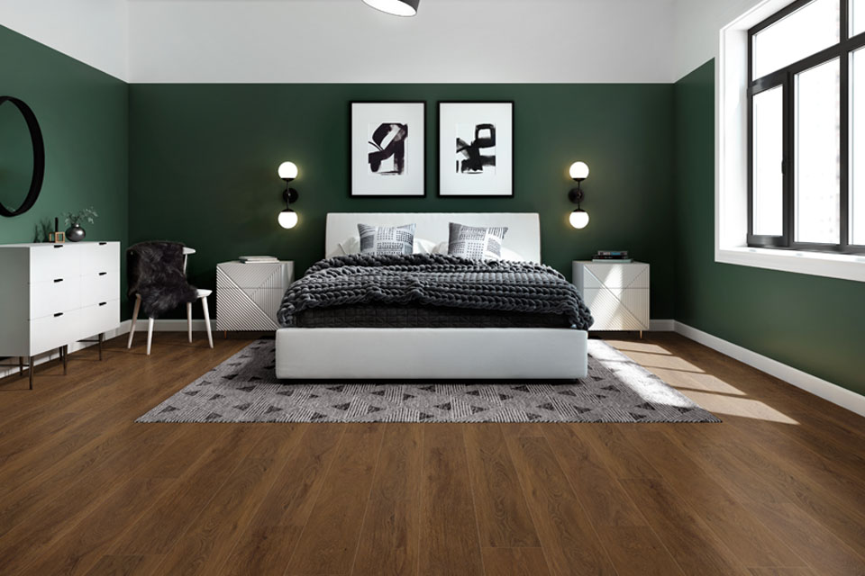 dark wood look flooring in green bedroom